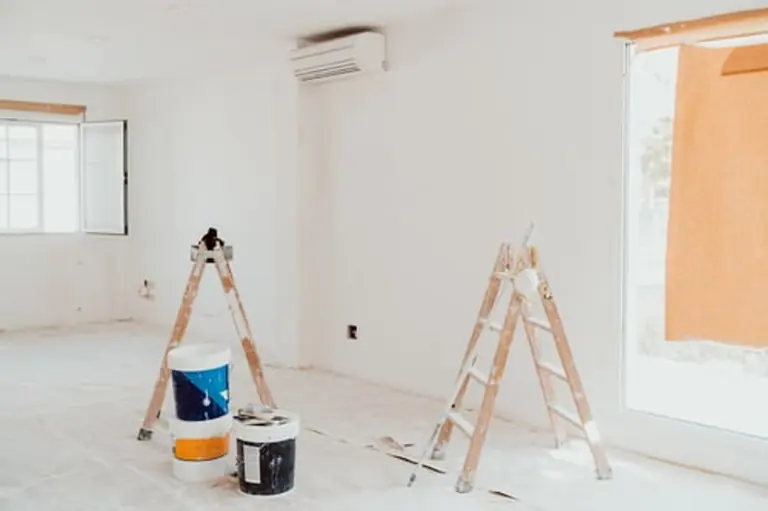 Gaytan's LLC crew masking and prepping a room before painting
